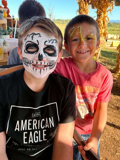 Boys with a skeleton full face and a lightning bolt design at a fall event, face painting by In His Image, Morristown TN